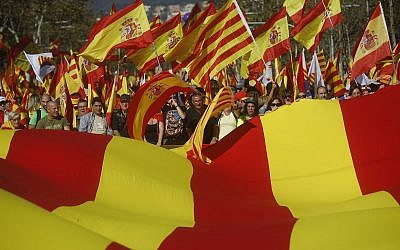 Nationalist activists protest with Spanish and Catalan flags during a mass rally against Catalonia's declaration of independence, in Barcelona, Spain, on October 29, 2017. (AP Photo/Santi Palacios)