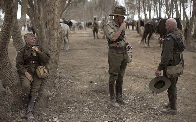 History enthusiasts and descendants of Australian Mounted Division and ANZAC (Australian and New Zealand Mounted Division) Mounted Division soldiers rest after the reenactment of the Battle of Beersheba when British and ANZAC forces captured Beersheba from the Ottoman Empire during the World War I, as part of the 100 years anniversary in near Beersheba, southern Israel, Monday, Oct. 30, 2017. (AP Photo/Oded Balilty)