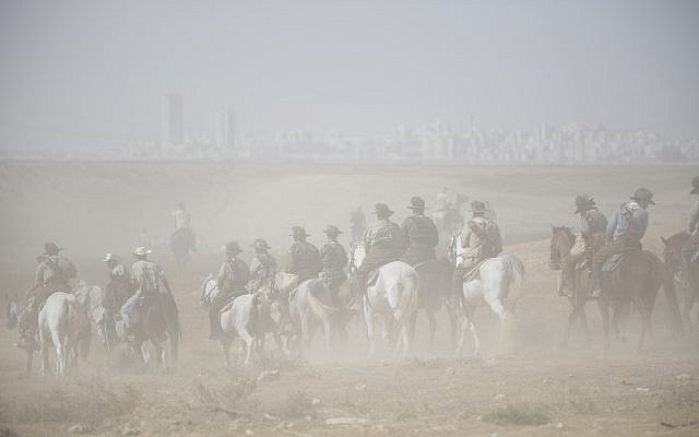 History enthusiasts and descendants of Australian Mounted Division and ANZAC (Australian and New Zealand Mounted Division) Mounted Division soldiers ride their horses during the reenactment of the Battle of Beersheba when British and ANZAC forces captured Beersheba from the Ottoman Empire during the World War I, as part of the 100 years anniversary in near Beersheba, southern Israel, Monday, Oct. 30, 2017. (AP Photo/Oded Balilty)