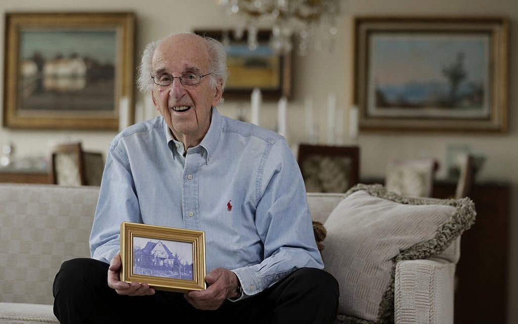 Peter Hirschmann holds a photograph of his childhood home in his current home in Maplewood, New Jersey, June 16, 2017. (AP Photo/Julio Cortez) Peter Hirschmann holds a photograph of his childhood home in his current home in Maplewood, New Jersey, June 16, 2017. (AP Photo/Julio Cortez)