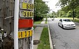 In this Aug. 5, 2017, file photo, a vehicle drives past polyvinyl chloride piping attached to a utility pole, signifying an outdoor area known as an eruv where Jewish residents observing certain restrictions during the Sabbath are permitted to carry items from home, along Airmount Road in Mahwah, N.J.  (AP Photo/Julio Cortez, File)