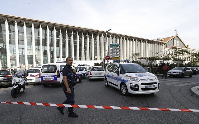 A French police officer cordons off the access to Marseille's main train station Sunday, Oct. 1, 2017 in Marseille, southern France. (AP Photo/Claude Paris)