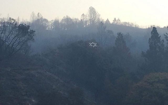 Surrounded by blackened vegetation, Camp Newman’s iconic hillside Star of David survived a wildfire in Northern California. (Courtesy of URJ Camp Newman) Surrounded by blackened vegetation, Camp Newman’s iconic hillside Star of David survived a wildfire in Northern California. (Courtesy of URJ Camp Newman)