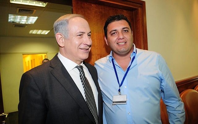Israeli Prime Minister Benjamin Netanyahu and Spotoption founder Pini Peter pose together at a charity event in the Prime Minister's Office in October 2011 (Berele Sheiner) Israeli Prime Minister Benjamin Netanyahu and Spotoption founder Pini Peter pose together at a charity event in the Prime Minister's Office in October 2011 (Berele Sheiner)