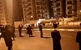 Screen capture from video showing supporters of the Beitar Jerusalem soccer club and ultra-Orthodox protesters throwing stones at each in Jerusalem, October 29, 2017. (YouTube/Hadashot Kol HaOlam Kulo)