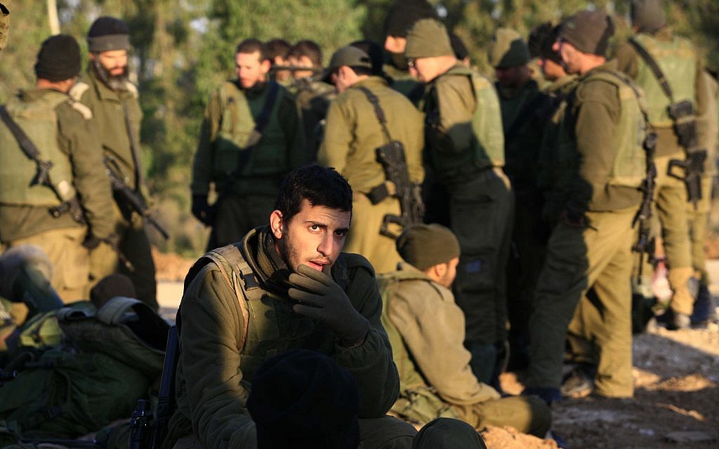Illustrative image of Israeli infantry soldiers resting on their equipment early on 13 January 2009 (Nati Shohat/Flash90) Illustrative image of Israeli infantry soldiers resting on their equipment early on 13 January 2009 (Nati Shohat/Flash90)