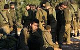 Illustrative image of Israeli infantry soldiers resting on their equipment early on 13 January 2009 (Nati Shohat/Flash90)