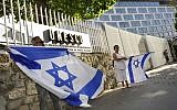File: French Jews hold Israeli flags as they demonstrate against UNESCO, near the cultural agency's Paris headquarters, July 17, 2017. (Serge Attal/Flash90)