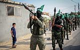 Members of the Ezzedine al-Qassam Brigades, the military wing of the Palestinian Islamist terror movement Hamas, take part in a rally marking three years since Operation Protective Edge, on July 20, 2017, in Khan Younis, in the southern Gaza Strip. (Abed Rahim Khatib/ Flash90)