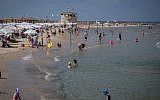 Israelis enjoy the beach in Tel Aviv. August, 2017. (Miriam Alster/FLASH90/File)