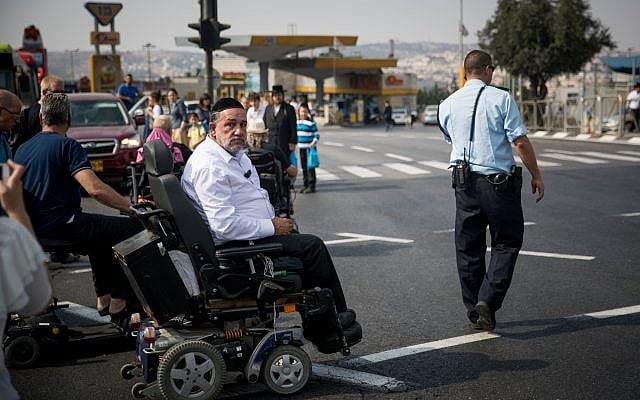 Disabled, handicapped and activists block the entrance to Jerusalem as they attend a protest calling for better health care, September 18, 2017. (Yonatan Sindel/Flash90) Disabled, handicapped and activists block the entrance to Jerusalem as they attend a protest calling for better health care, September 18, 2017. (Yonatan Sindel/Flash90)