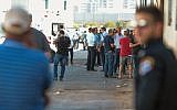 Police at the scene where Reuven Schmerling from the settlement of Elkana was found dead at the industrial zone in Kafr Qassem, October 4, 2017. (Roy Alima/Flash90)