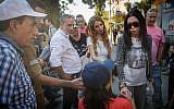 Businesswoman Nicol Raidman, right, speaks with disabled rights protester Hannah Akiva, center, and other activists at the entrance to the Prime Minister's Residence, Jerusalem, October 17, 2017. (Yonatan Sindel/Flash90)