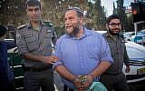 Lehava chairman Benzi Gopstein is brought to the Jerusalem Magistrate's Court, October 22, 2017 (Yonatan Sindel/Flash90)