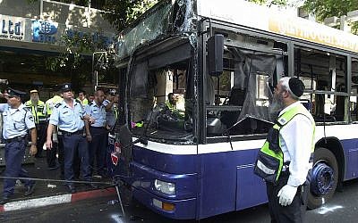 Illustrative: Israeli police and aid workers search the scene of a suicide bomb attack in a bus on September 19, 2002 in Tel Aviv. (Rahanan Cohen/Israel Defense Forces/Getty Images via JTA/File)