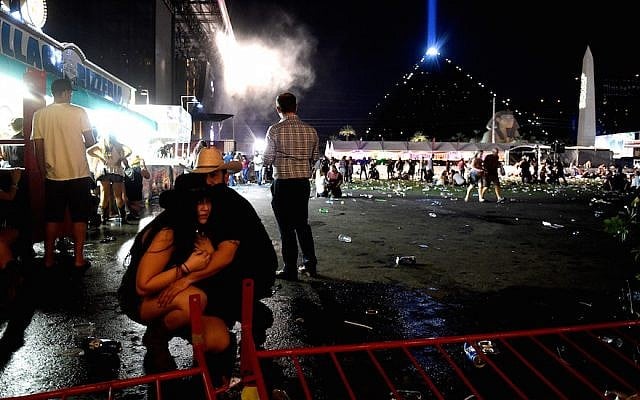 Concertgoers taking cover at a country music festival on the Las Vegas Strip following a mass shooting attack, October 1, 2017. (David Becker/Getty Images) Concertgoers taking cover at a country music festival on the Las Vegas Strip following a mass shooting attack, October 1, 2017. (David Becker/Getty Images)