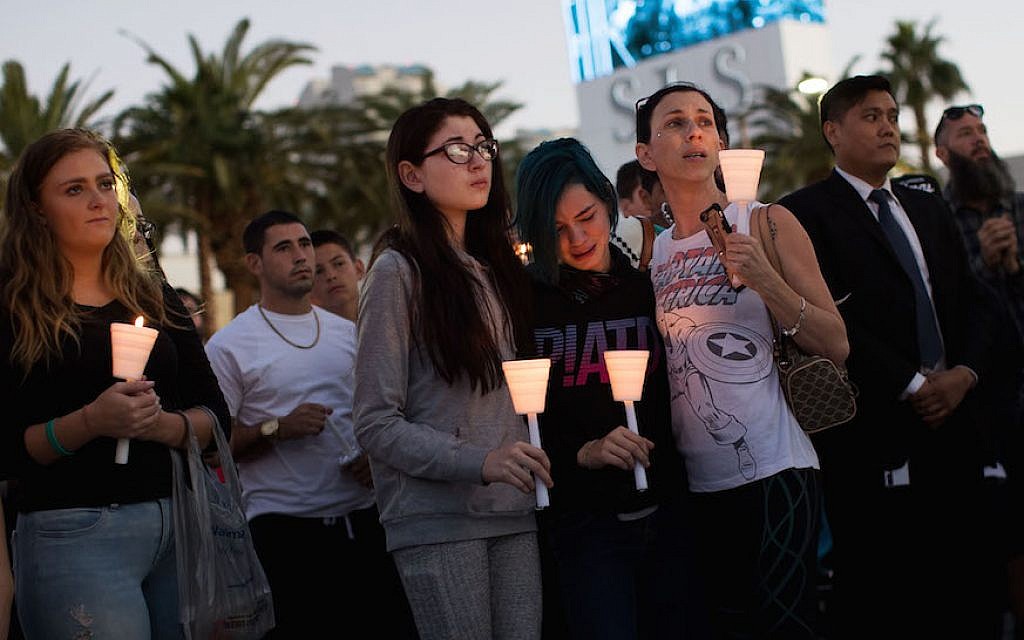 Mourners attending a candlelight vigil in Las Vegas for the victims of the mass shooting there, Oct. 2, 2017. (Drew Angerer/Getty Images, via JTA) Mourners attending a candlelight vigil in Las Vegas for the victims of the mass shooting there, Oct. 2, 2017. (Drew Angerer/Getty Images, via JTA)