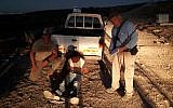Jewish farmers pose next to a Palestinian man who tried to attack the owner of Talia Farm in the West Bank on October 24, 2017. (Har Hebron Regional Council)