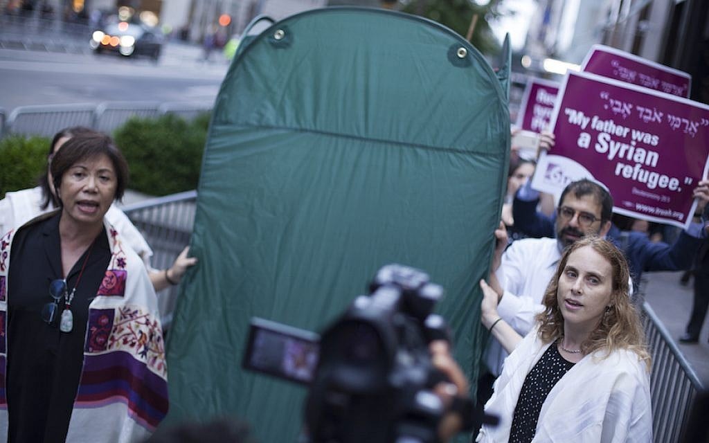 Rabbis from T’ruah: The Rabbinic Call for Human Rights, carry a pop-up sukkah in a demonstration for immigrants’ rights outside the Trump Tower in New York, October 9, 2017. (Courtesy of T’ruah) Rabbis from T’ruah: The Rabbinic Call for Human Rights, carry a pop-up sukkah in a demonstration for immigrants’ rights outside the Trump Tower in New York, October 9, 2017. (Courtesy of T’ruah)