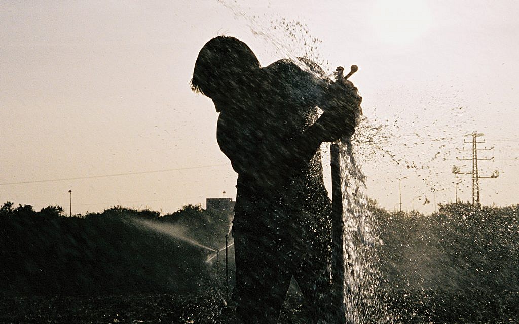 A man fixes a broken sprinkler in a field in the Hefer Valley. (illustrative photo: Gili Yaari /Flash90) A man fixes a broken sprinkler in a field in the Hefer Valley. (illustrative photo: Gili Yaari /Flash90)