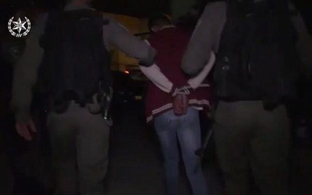 Police arrest a resident of East Jerusalem's Issawiya neighborhood suspected of taking part in a violent demonstration as part of a large-scale raid on October 23, 2017. (Screen capture/Israel Police) Police arrest a resident of East Jerusalem's Issawiya neighborhood suspected of taking part in a violent demonstration as part of a large-scale raid on October 23, 2017. (Screen capture/Israel Police)