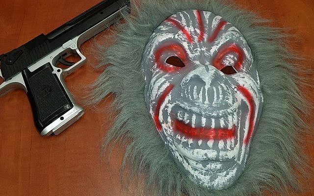 Clown mask and plastic gun confiscated from teenager in Nazareth Illit, October 6, 2017. (Israel police) Clown mask and plastic gun confiscated from teenager in Nazareth Illit, October 6, 2017. (Israel police)