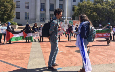 University of California Berkeley junior Adah Forer speaks to a student in front of a pro-Palestinian demonstration on campus. (Courtesy)
