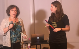 Karen Benezra, left, and Catherine Goldberg, leading the havdalah blessings at a recent 'Chai Havdalah' event in Brooklyn. (Lucy Cohen Blatter/via JTA)