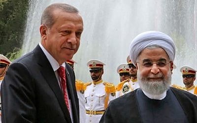 A handout picture provided by the Iranian Presidency shows Iran's President Hassan Rouhani, right, with Turkish President Recep Tayyip Erdogan during a welcome ceremony in Tehran on October 4, 2017. (AFP PHOTO / Iranian Presidency / HO)