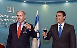 Yossi Cohen, right, head of the Mossad secret service, raises a toast together with Prime Minister Benjamin Netanyahu, ahead of the upcoming Jewish New Year at the PM's office in Jerusalem on September 7, 2015.  (Haim Zach / GPO)
