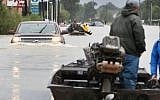 Rescue workers and volunteers help residents make their way out of a flooded neighborhood after it was inundated with rain water following Hurricane Harvey on August 29, 2017 in Houston, Texas. (Scott Olson/Getty Images)
