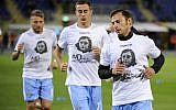 Lazio players wear a shirt depicting Anne Frank saying "No to anti-Semitism," in response to anti-Semitic stickers left by their fans at a previous match, during the Serie A match between Bologna FC and SS Lazio at Stadio Renato Dall'Ara in Bologna, Italy, on October 25, 2017. (Marco Rosi/Getty Images via JTA)