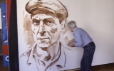 Marc Klionsky painting one of his famed portraits. (Screen capture: YouTube)