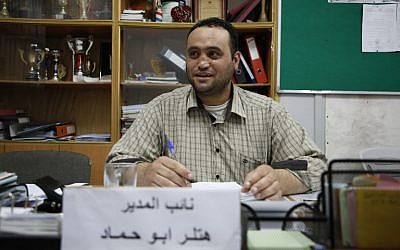 Palestinian Hitler Abu Hamad, deputy head at a school, sits at his office in the West Bank city of Hebron, on September 26, 2017. (AFP PHOTO / HAZEM BADER)