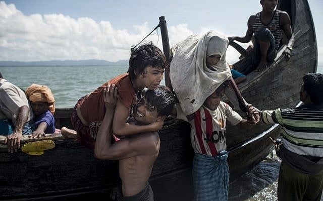 Bangladeshi men help Rohingya Muslim refugees to disembark from a boat on the Bangladeshi shoreline of the Naf river after crossing the border from Myanmar in Teknaf on September 30, 2017. (AFP PHOTO / FRED DUFOUR) Bangladeshi men help Rohingya Muslim refugees to disembark from a boat on the Bangladeshi shoreline of the Naf river after crossing the border from Myanmar in Teknaf on September 30, 2017. (AFP PHOTO / FRED DUFOUR)