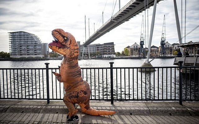 Illustrative: A cosplayer dressed as a dinosaur attends the MCM Comic Con at ExCeL exhibition centre in London on October 28, 2017. (AFP/Tolga AKMEN) Illustrative: A cosplayer dressed as a dinosaur attends the MCM Comic Con at ExCeL exhibition centre in London on October 28, 2017. (AFP/Tolga AKMEN)