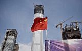 A Chinese flag flies at a construction site in Beijing's central business district on October 31, 2017. (AFP Photo/Greg Baker)