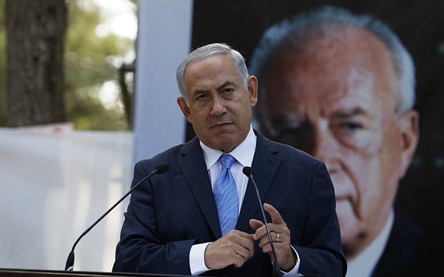 Prime Minister Benjamin Netanyahu speaks during a memorial ceremony to mark the 22nd anniversary of the assassination of former prime minister Yitzhak Rabin at the military cemetery on Mount Herzl in Jerusalem, on November 1, 2017. (AFP/Pool/Ronen Zvulun/ File) Prime Minister Benjamin Netanyahu speaks during a memorial ceremony to mark the 22nd anniversary of the assassination of former prime minister Yitzhak Rabin at the military cemetery on Mount Herzl in Jerusalem, on November 1, 2017. (AFP/Pool/Ronen Zvulun/ File)