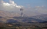 Illustrative: Smokes billows from the southern Syrian Druze village of Hadar on November 3, 2017, as seen from the Israeli Golan Heights. (AFP/JALAA MAREY)