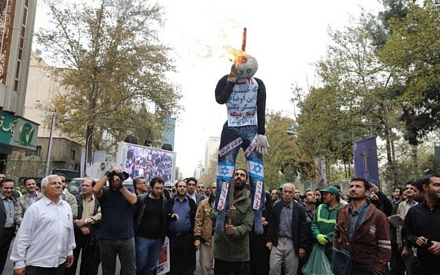 Iranians burn a doll representing Israel and America during a demonstration outside the former US embassy in the Iranian capital Tehran on November 4, 2017, marking the anniversary of its storming by student protesters that triggered a hostage crisis in 1979. (AFP PHOTO / ATTA KENARE)
