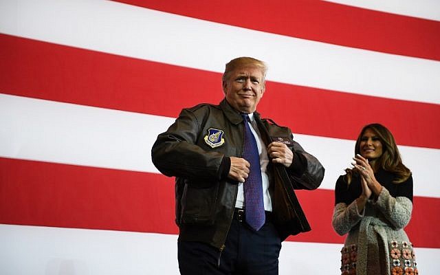 US President Donald Trump (R) prepares to addresse US soldiers as his wife Melania looks on upon arriving at US Yokota Air Base in Tokyo on November 5, 2017. AFP PHOTO / JIM WATSON US President Donald Trump (R) prepares to addresse US soldiers as his wife Melania looks on upon arriving at US Yokota Air Base in Tokyo on November 5, 2017. AFP PHOTO / JIM WATSON