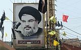 A portrait of the head of the Hezbollah terror group Hassan Nasrallah is seen on November 5, 2017, in the southern Lebanese village of Adshit. (AFP Photo/Mahmoud Zayyat)