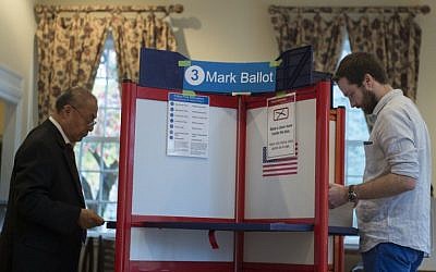 Two men vote at a polling station in Arlington, Virginia on November 7, 2017. (AFP / Andrew CABALLERO-REYNOLDS)
