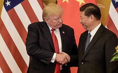 US President Donald Trump (L) shakes hand with China's President Xi Jinping at the end of a press conference at the Great Hall of the People in Beijing on November 9, 2017. (AFP PHOTO / Fred DUFOUR)