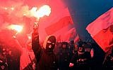 Demonstrators burn flares and wave Polish flags during the annual march to commemorate Poland's National Independence Day in Warsaw on November 11, 2017. (AFP/Janke )