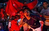 Moroccans celebrate November 11, 2017 in Marrakech following Morocco's victory over Ivory Coast in their FIFA 2018 World Cup Africa Qualifier to participate the FIFA 2018 World Cup. (AFP PHOTO / Fadel SENNA)