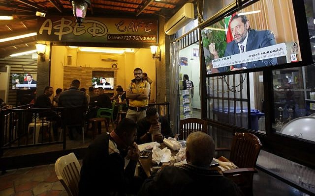 Lebanese watch an interview with Lebanon's resigned prime minister Saad Hariri at a coffee shop in Beirut on November 12, 2017.(AFP PHOTO / ANWAR AMRO)