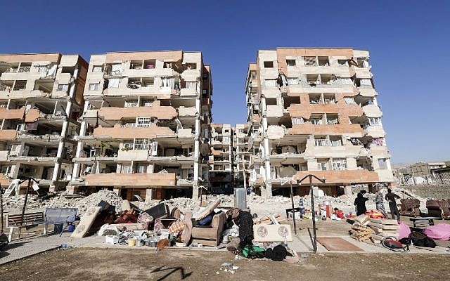 Iranians salvage their furniture and household appliances as they bring them outside the damaged buildings in the town of Sarpol-e Zahab in the western Kermanshah province near the border with Iraq, November 14, 2017. (AFP/ATTA KENARE) Iranians salvage their furniture and household appliances as they bring them outside the damaged buildings in the town of Sarpol-e Zahab in the western Kermanshah province near the border with Iraq, November 14, 2017. (AFP/ATTA KENARE)