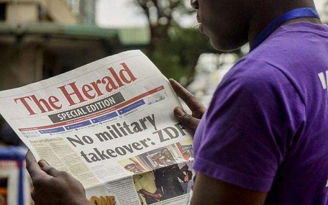 A man reads the front page of a special edition of The Herald newspaper about the crisis in Zimbabwe with the headline 'No military takeover - ZDF' on November 15, 2017 in Harare.(AFP PHOTO) A man reads the front page of a special edition of The Herald newspaper about the crisis in Zimbabwe with the headline 'No military takeover - ZDF' on November 15, 2017 in Harare.(AFP PHOTO)