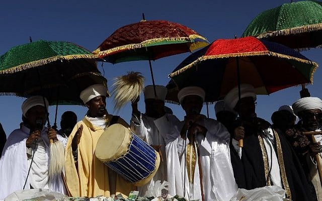 Israeli 'Kessim' or religious leaders of the Ethiopian Jewish community lead the prayers during the Sigd holiday marking the desire to 'return to Jerusalem', as they celebrate from a hilltop in the holy city, on November 16, 2017. (AFP PHOTO / GALI TIBBON)